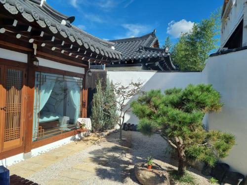 a house with a tree in the courtyard at EL House in Gyeongju