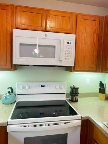 a kitchen with a microwave above a stove at Tahoe Snowbird Retreat in Stateline