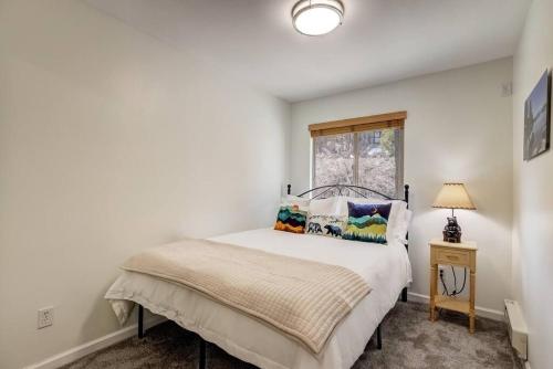 a white bedroom with a bed and a window at Tahoe Snowbird Retreat in Stateline