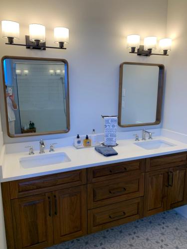 a bathroom with two sinks and a large mirror at Ocean Front Private Suite in Victoria