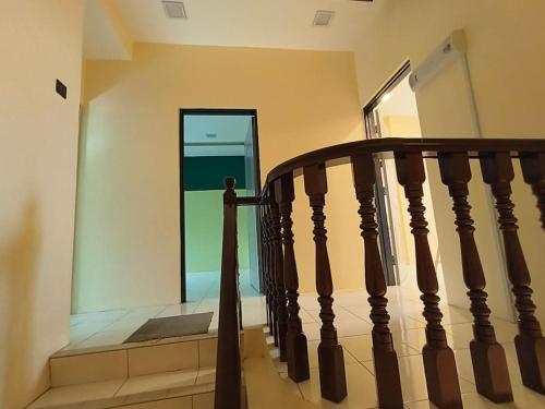 a wooden staircase in a house with a window at (WI-FI) Ipoh Holiday Big House double storey DR8 in Ipoh