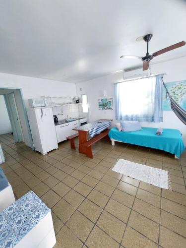 a living room with a couch and a refrigerator at Pousada Los Casarones in Florianópolis