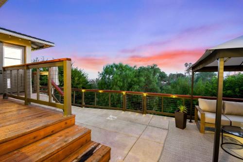 a deck with a couch and a chair on a balcony at South Park - Mountain Views - Central - Tranquil in San Diego