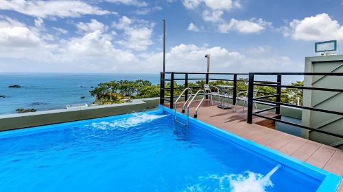 a swimming pool with a view of the ocean at Beachhill Pool Villa in Gyeongju