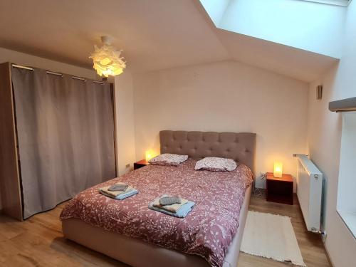 a bedroom with a bed with two towels on it at Maison de charme rénovée proche Verdun, idéal randos, 3 ch, jardin, terrasse, cuisine équipée - FR-1-585-48 in Forges-sur-Meuse
