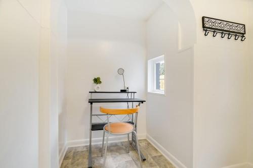 a stool in a room with a table and a window at Cozy Retreat in Downtown Lancaster with Backyard Patio in Lancaster