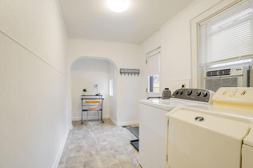 a white kitchen with a sink and a window at Cozy Retreat in Downtown Lancaster with Backyard Patio in Lancaster