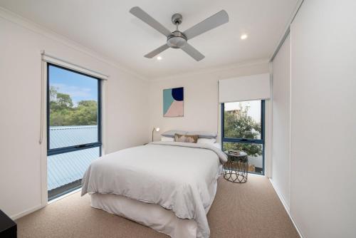 a bedroom with a bed and a ceiling fan at Bass Ocean Sunsets Cape Schanck in Cape Schanck
