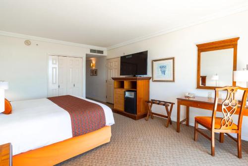 a hotel room with a bed and a desk and a television at Camino Real Puebla Angelopolis in Puebla