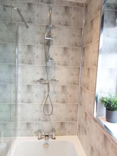 a bathroom with a shower and a sink at Croeso; Cosy and ideally located for mountains and beaches in Deganwy