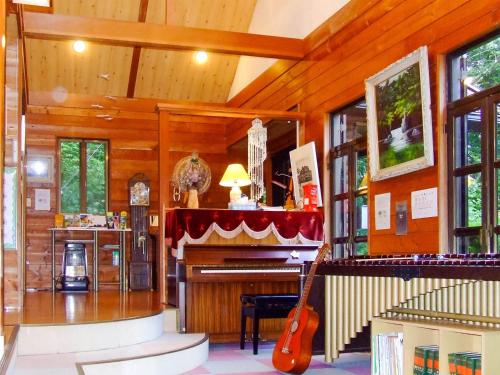 a living room with a piano and a guitar at Minamitsuru-gun - Hotel / Vacation STAY 45545 in Yamanakako