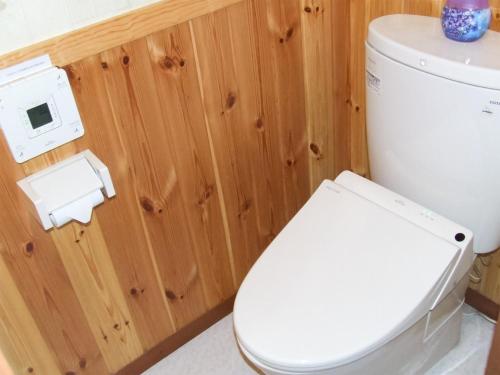 a bathroom with a toilet and a toilet paper dispenser at Minamitsuru-gun - Hotel / Vacation STAY 45545 in Yamanakako