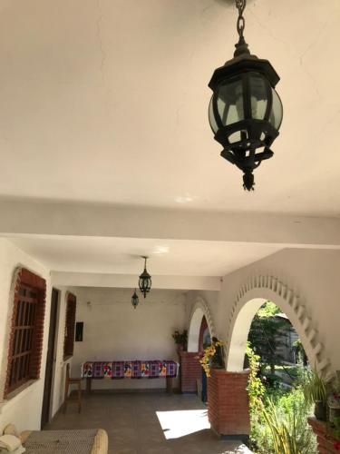 a large room with a light hanging from a ceiling at Alojamiento en una tranquila casa rural 