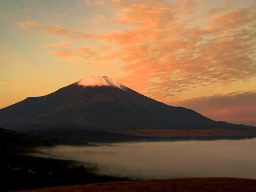 a mountain with a reflection in the water at sunset at Minamitsuru-gun - Hotel / Vacation STAY 45535 in Yamanakako