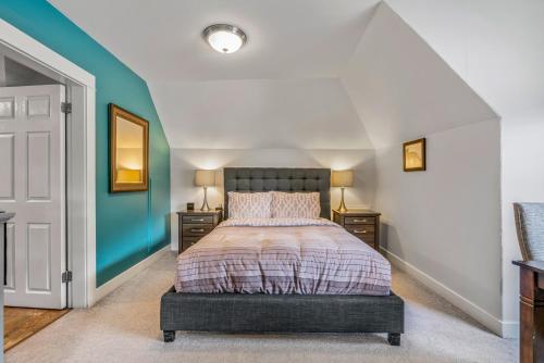 a bedroom with a bed and two night stands at Cloudside Hotel in Nelson