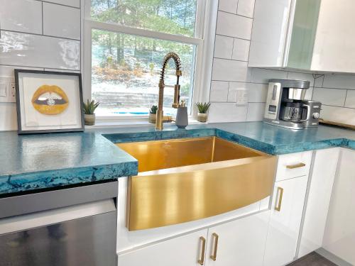 a kitchen with a gold sink and a window at Luxury 4 bedroom 2 bath Lake Views in Marlborough