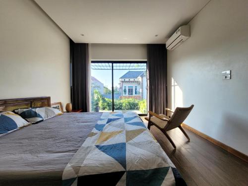 a bedroom with a large bed and a large window at Noi Bai Flight Path Homestay in Hanoi