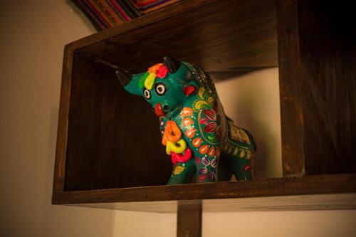 a figurine of a dog in a wooden box at Sky Dome Peru in Cusco