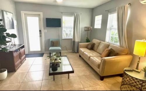 a living room with a couch and a table at The Agustin Guesthouse - Men Only Clothing Optional in Fort Lauderdale