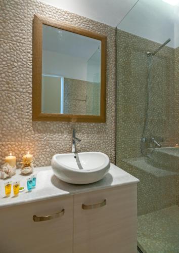 a bathroom with a sink and a shower at Cape Mykonos in Mýkonos City