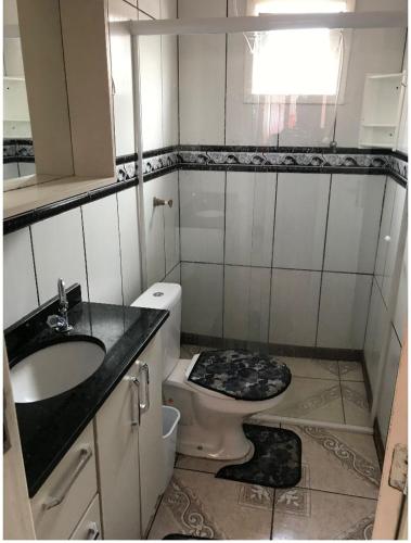 a small bathroom with a sink and a toilet at Casa praia da cal in Torres