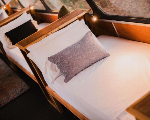 a bed with a pillow on top of it at Bounce Magnetic Island and Koala Park - formerly Roamer in Horseshoe Bay