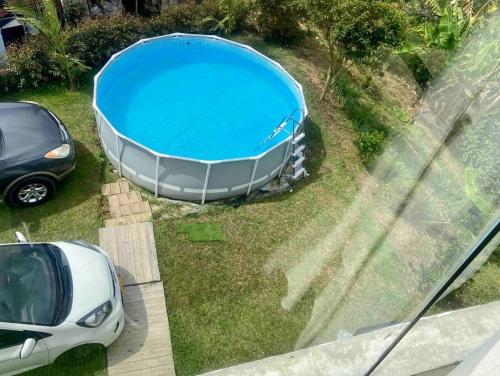 a car parked next to a large blue pool at BERAKHAH SPA & ROOMS in Guatapé