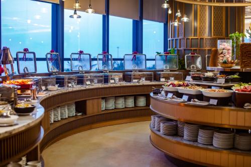 a buffet line with plates of food on display at Peninsula Hotel Danang in Danang