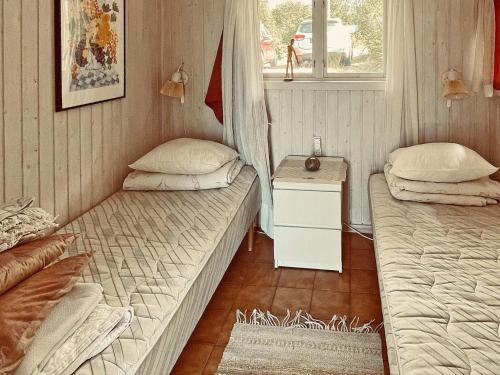 a room with two beds and a table and a window at 4 star holiday home in VARBERG-By Traum in Varberg