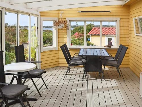 a patio with a table and chairs on a deck at 4 star holiday home in VARBERG-By Traum in Varberg