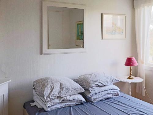 a bedroom with a bed with a mirror on the wall at 4 star holiday home in VARBERG-By Traum in Varberg