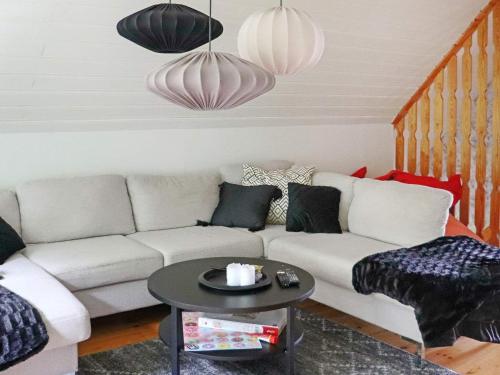 a living room with a white couch and a table at 4 star holiday home in ULLARED-By Traum in Ullared