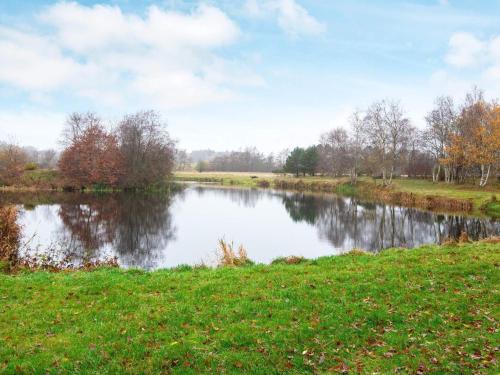 a river in a field next to a grass field at Lakefront Gem in Skarrild - By Traum Ferienwohnungen in Kibæk