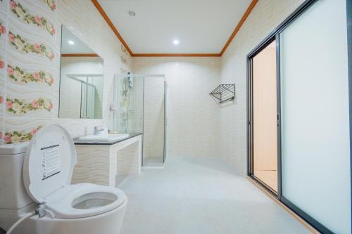 a bathroom with a toilet and a sink and a shower at Tayama Farm Khaoyai in Nakhon Ratchasima