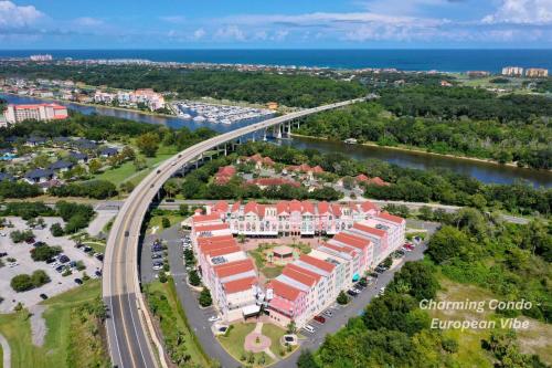 an aerial view of a resort with a bridge over a river at Charming Condo - European Vibe in Palm Coast