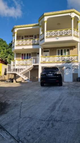 a car parked in front of a building at Homely Escapes by Pulse in Loubiere