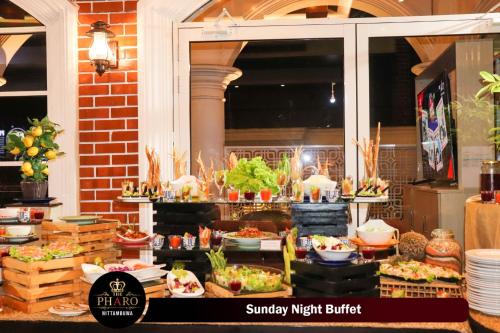 a buffet of food is shown in a window at The Pharo in Nittambuwa