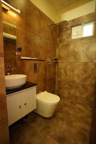 a bathroom with a toilet and a sink at Pabis luxurious stay in Vythiri