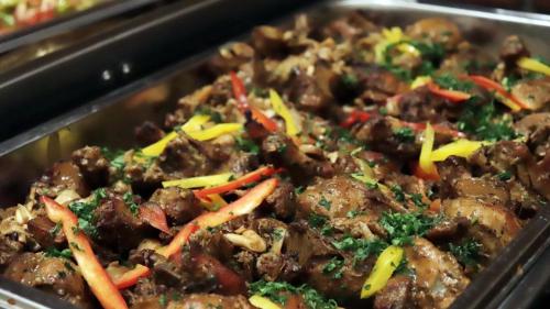 a dish of food with meat and vegetables in a pan at The Pharo in Nittambuwa