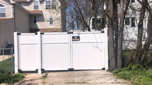 a white gate in front of a house at cozzy room with private entrance and drive way in Arlington