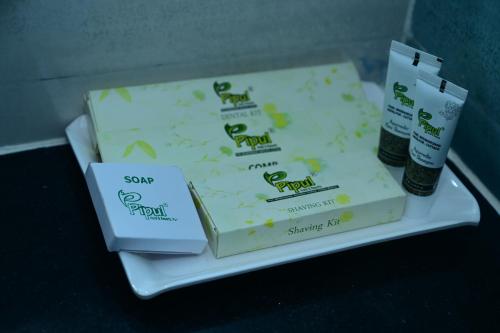 two boxes of soap sitting on a tray at Pipul Ocean View Resort in Puri