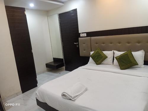 a hotel room with a bed with a towel on it at Hotel BKC Palace Inn - Near US Consulate, Bandra Kurla Complex హోటల్ బి కే సి ప్యాలెస్ ఇన్ in Mumbai