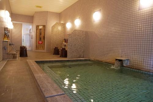 a pool of water in a bathroom with at 北軽井沢　Golden Forest Hotel in Naganohara