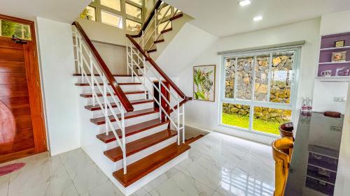 a winding staircase in a home with a window at Caliraya Heights Resorts and Events Place in Halang