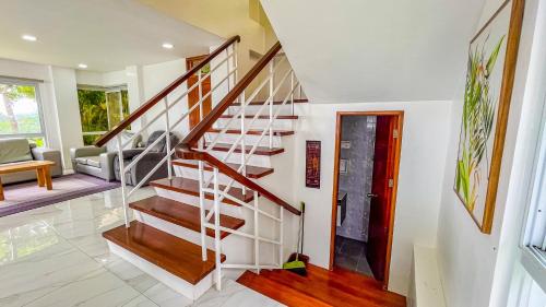 a staircase in a house with a living room at Caliraya Heights Resorts and Events Place in Halang