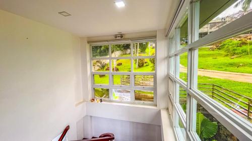 a window in a house with a view at Caliraya Heights Resorts and Events Place in Halang