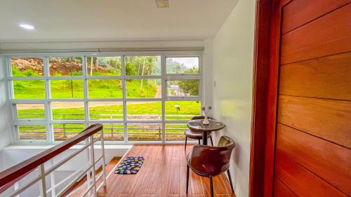 a room with a large window and a wooden floor at Caliraya Heights Resorts and Events Place in Halang