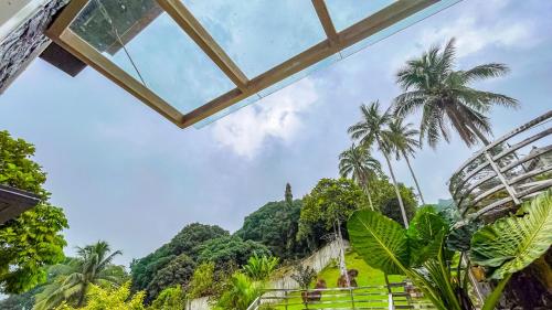 a view from the top of a building with palm trees at Caliraya Heights Resorts and Events Place in Halang