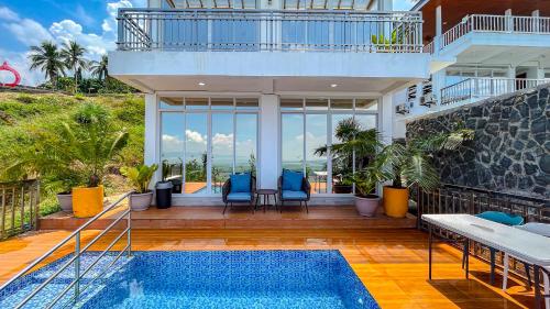 a house with a swimming pool and a patio at Caliraya Heights Resorts and Events Place in Halang