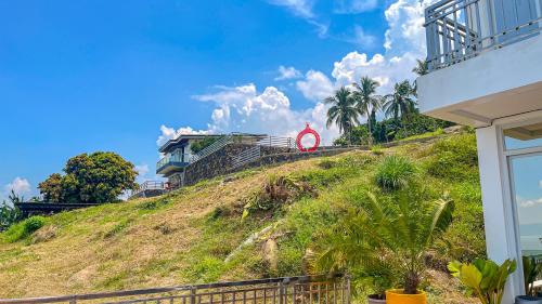 a house on a hill with a sign on it at Caliraya Heights Resorts and Events Place in Halang